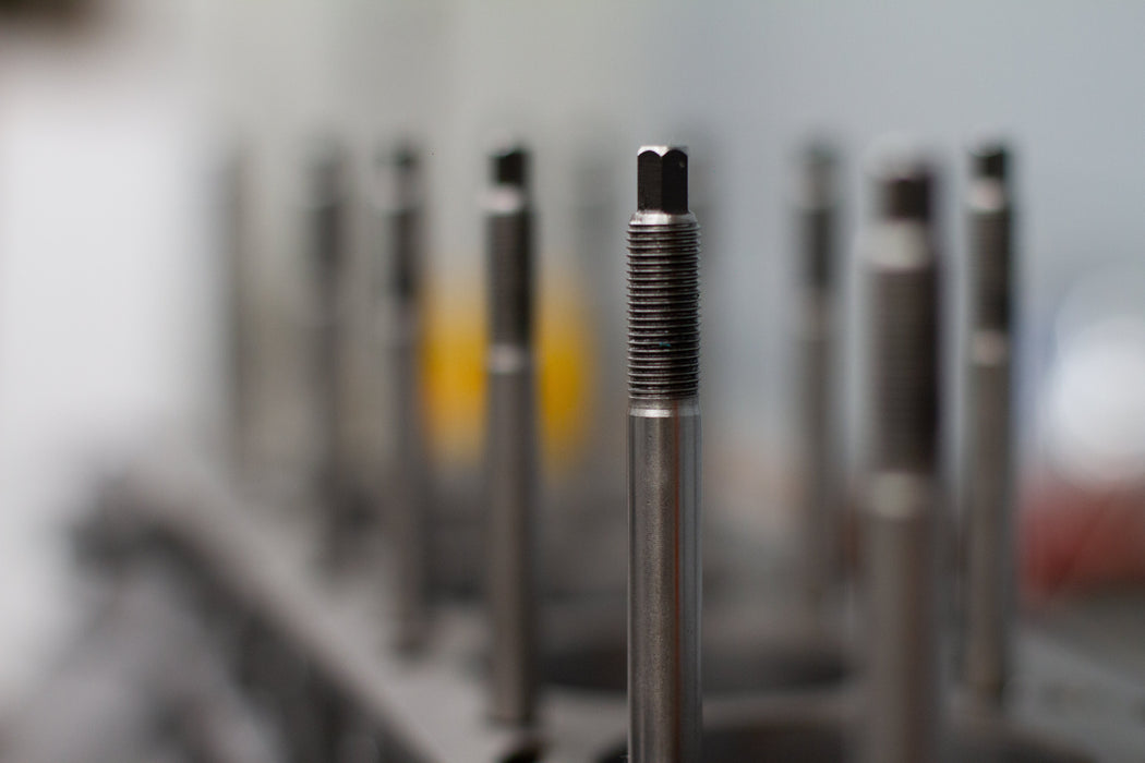 metal head stud in engine block with blurred background