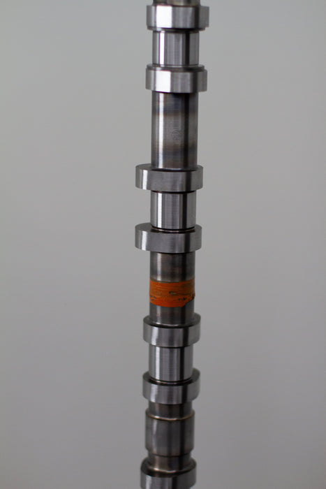 Metal camshaft on a gray background