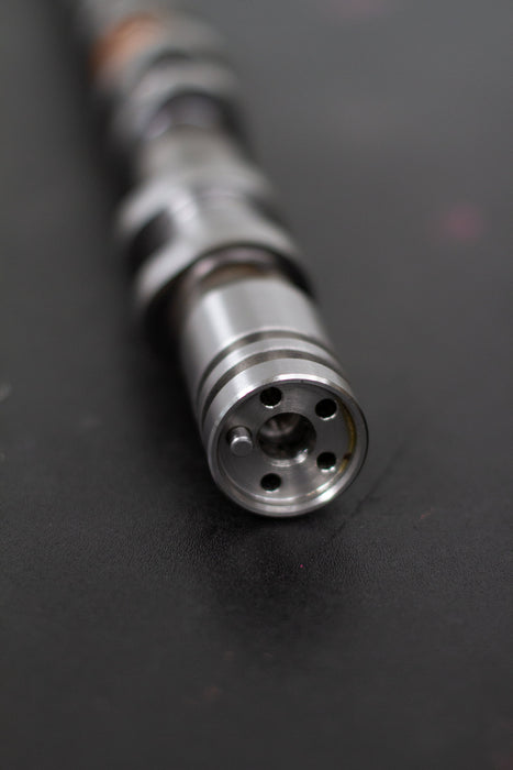 Close-up of a camshaft dowel on a dark background