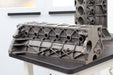 engine cast block on a black bench