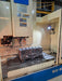 cast engine block being machined