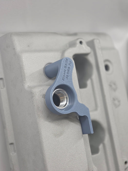 close up of weld on orb with 3d printed fitting jig on engine rocker cover with white background