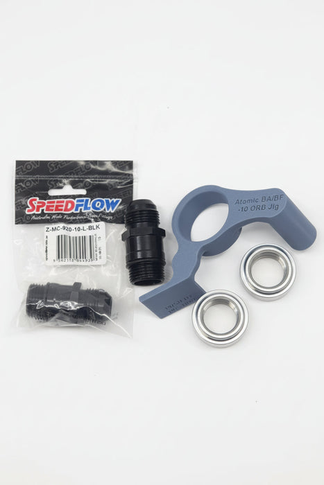 speedflow packaging of black weld on bungs with aluminium extension fittings and 3d printed fitting jigs with white background