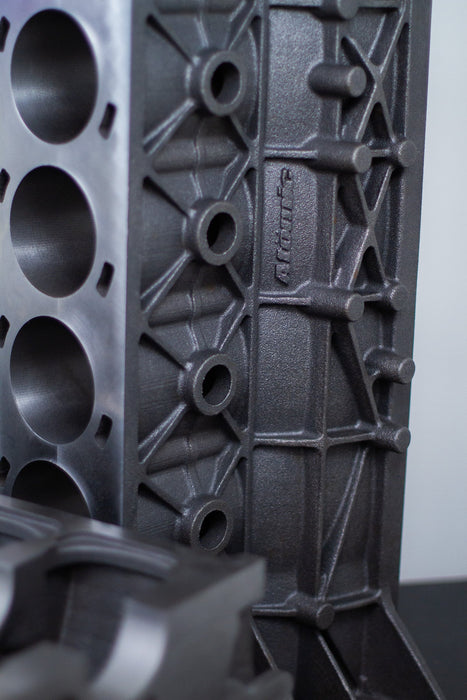 gray upright cast engine block with white background