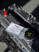 atomic label and tag on grey engine rocker cover with black oil cap and red cap